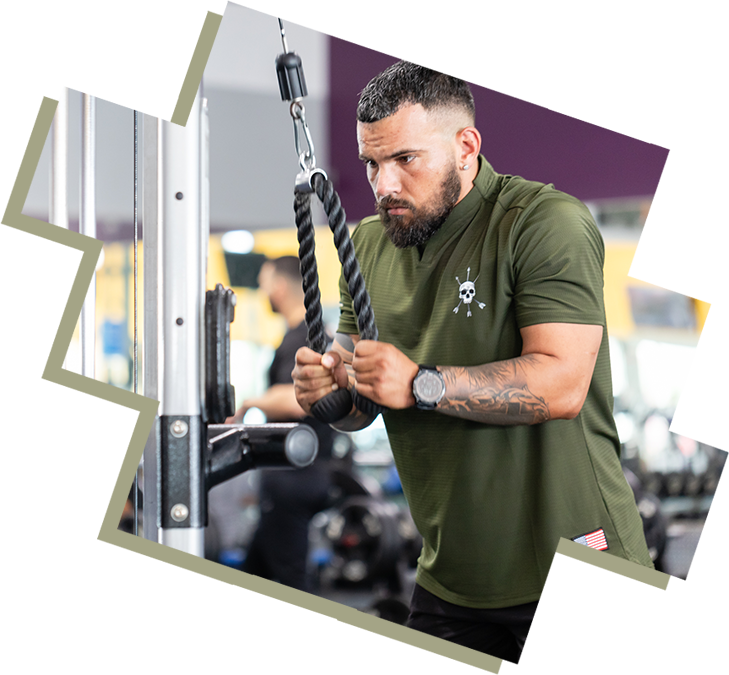 A man holding onto some ropes in the gym