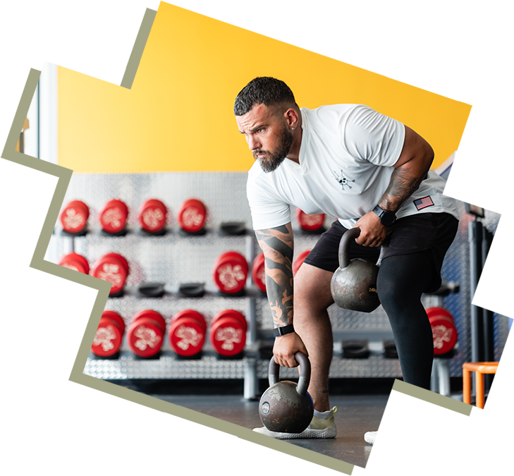 A man is lifting a kettlebell in the gym.